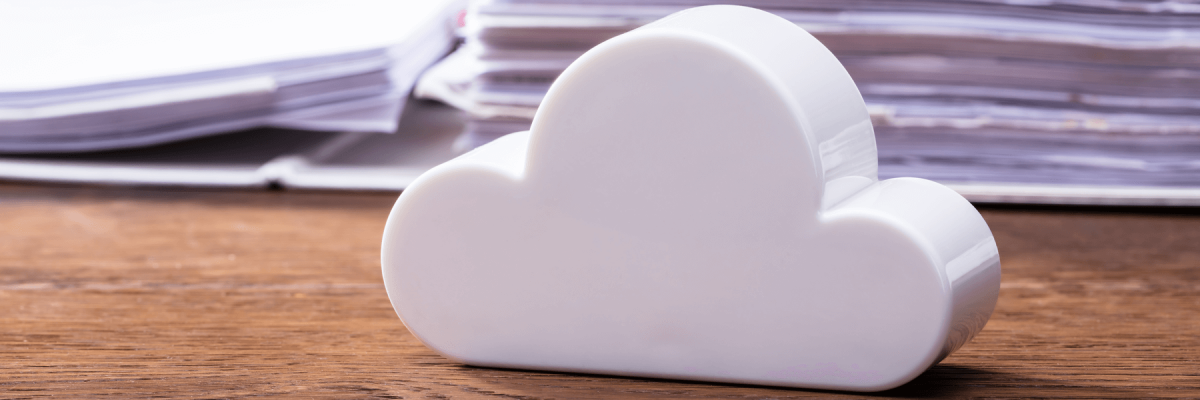 Close-up Of White Cloud Block In Front Of Documents On A Wooden Table