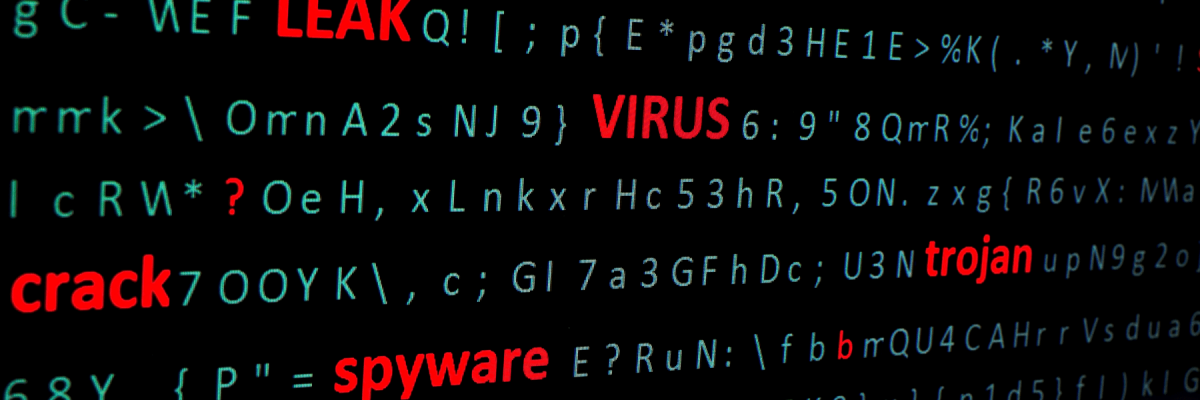 Side view of a pc monitor, a string of words leak, virus, spyware, Trojan highlighting in red font among a chaotic set of green computer symbols. 