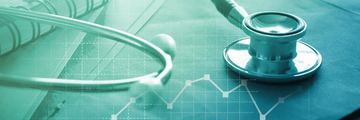 Medical examination and healthcare business graph, stethoscope, and notepad. Health check concept. Blue and green filter over image.