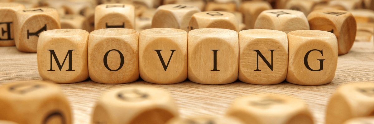 Moving word written on wood blocks surrounded by other random blocks that are out of focus 